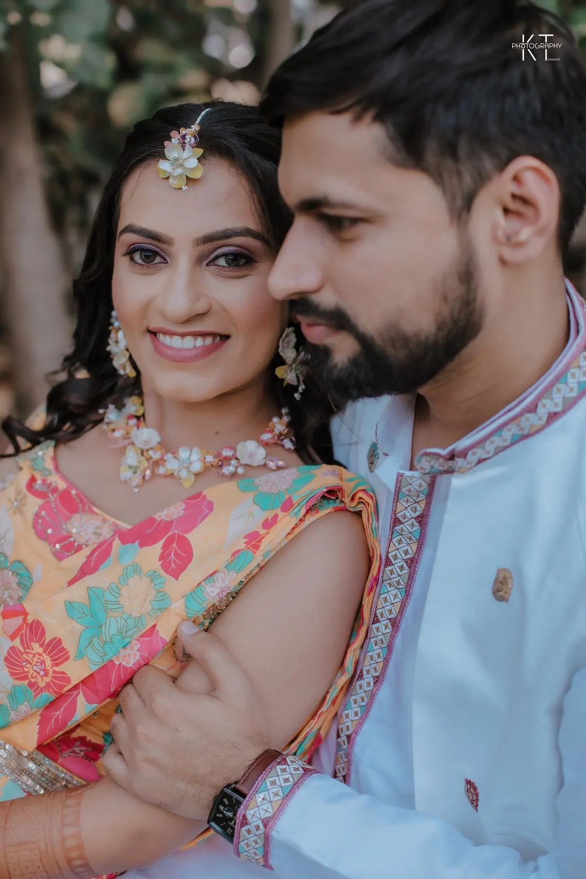 Jay & Riya smiling together in a haldi portrait