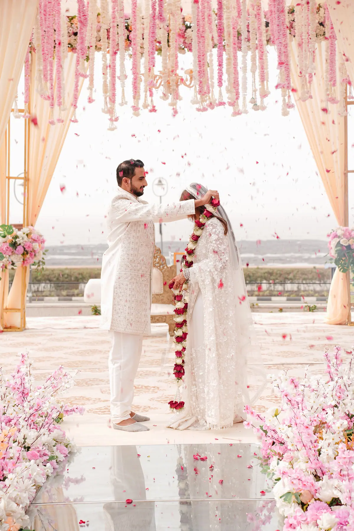 Monika & Aman beneath their floral wedding canopy